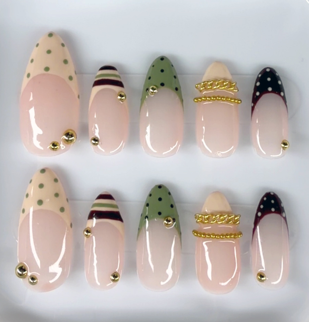 Sage Society hand-painted press-on nail set with green polka dots, gold chain accents, and glossy nude base